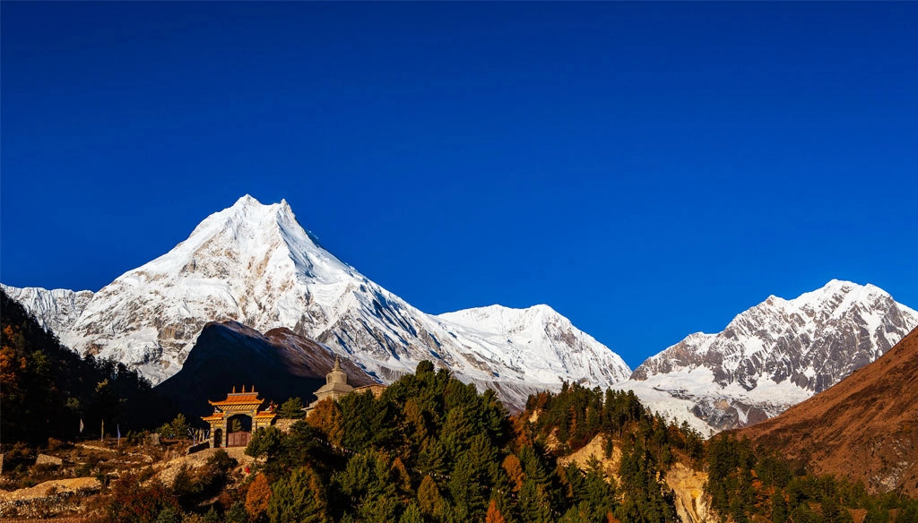 A stunning view of Mount Manaslu, Naike peak and Manaslu North is captured Near the Lo-Gaun.