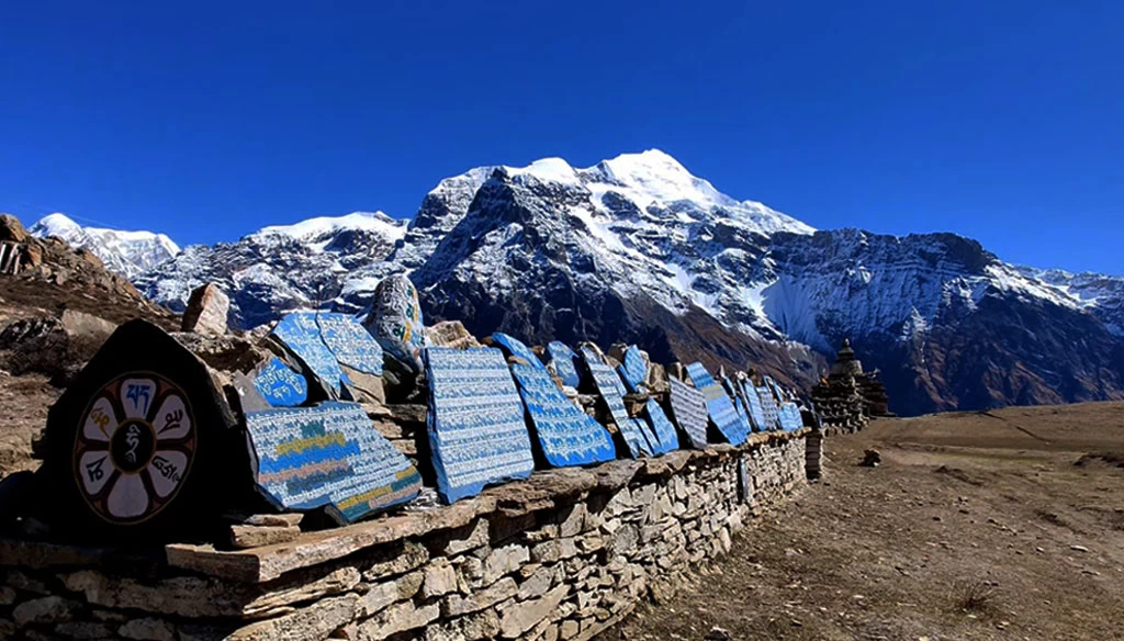 A beautiful Mani-wall and mountains in the background is pictured during the Nar Phu valley trekking.