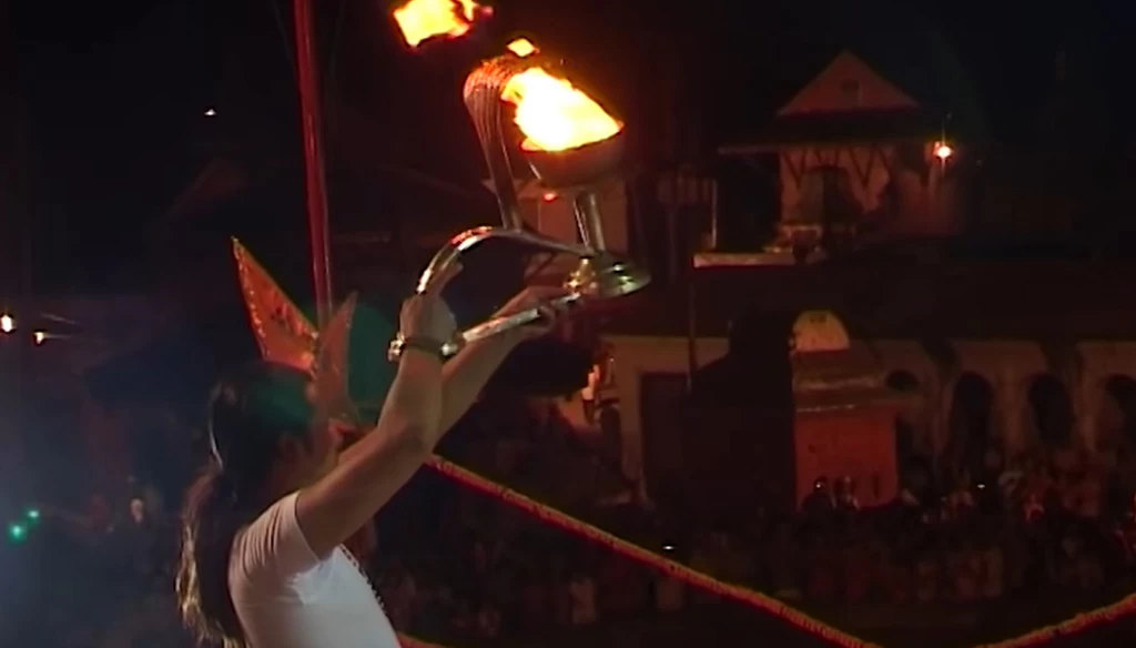 priest offering oil lamp during the evening aarati in pashupatinath