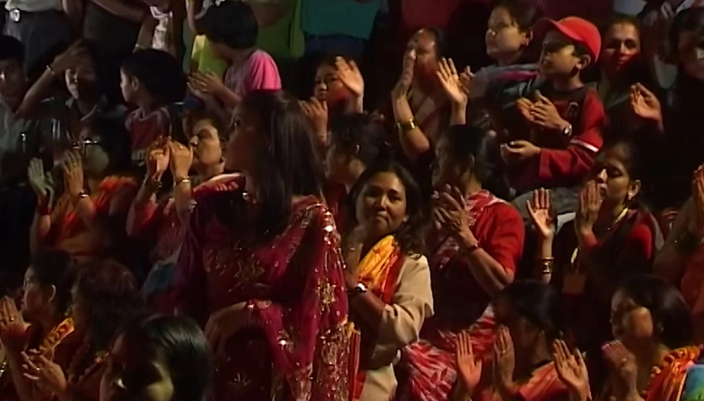 pilgrimage are clapping during the aarati in pashupatinath kathmandu