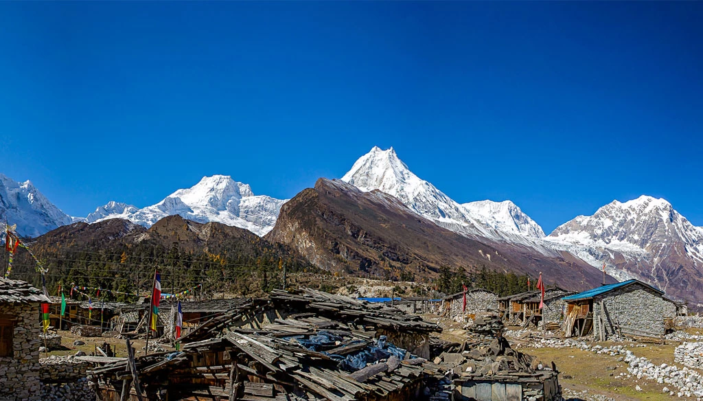 old village of syala village and the view of mount manaslu, naike peak, nadi chuli is pictured during manaslu circuit trek