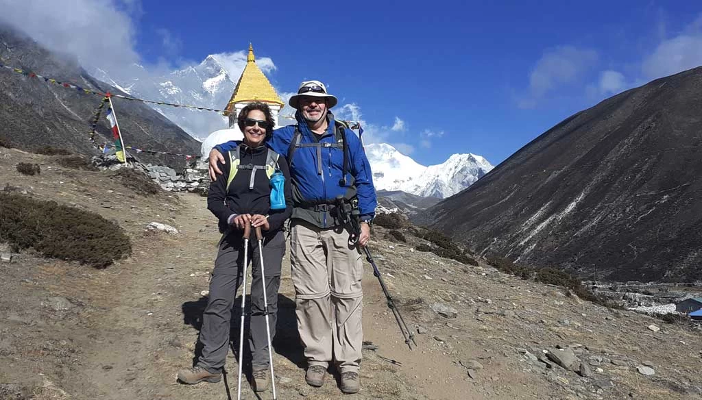 senior citizen taking picture after reaching Dingboche during EBC trekkiing.