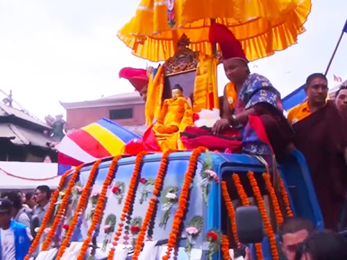 a statue of buddha is taking around the boudhanath during the buddha jayanti festival